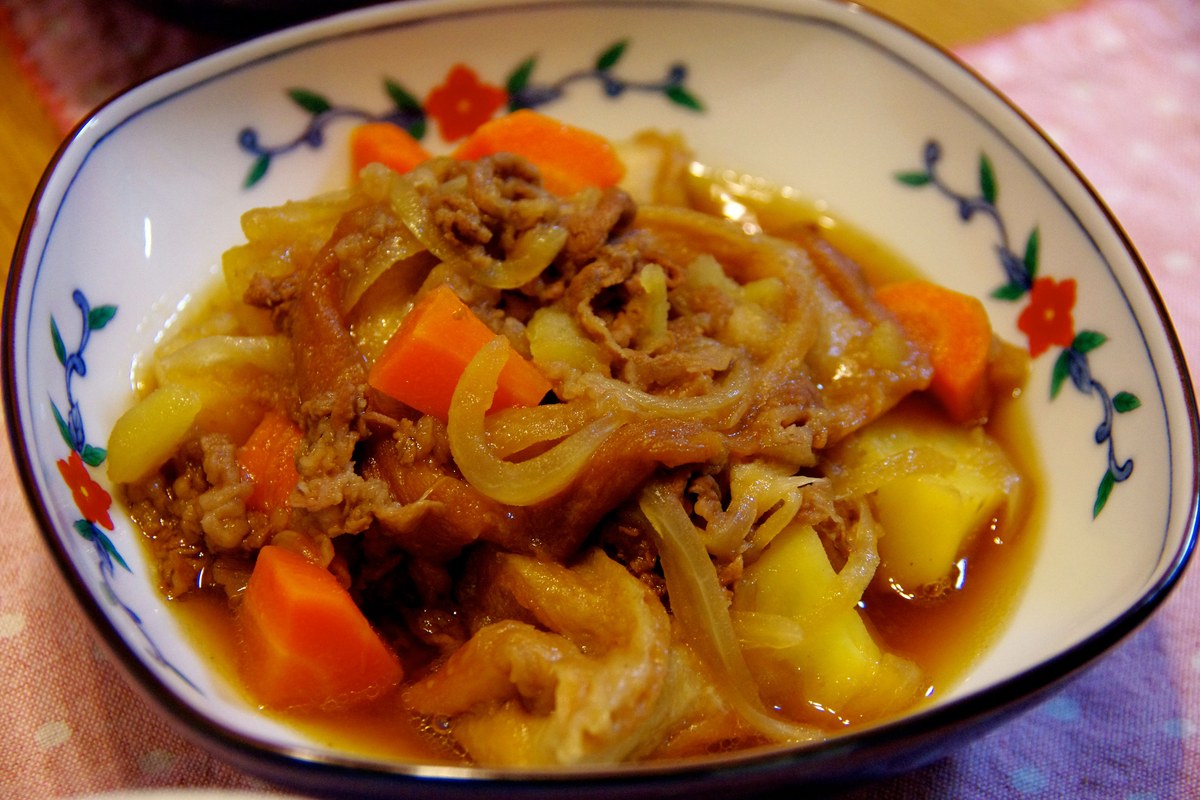Braised beef and potatoes in a glossy soy-colored sauce with tender chunks.