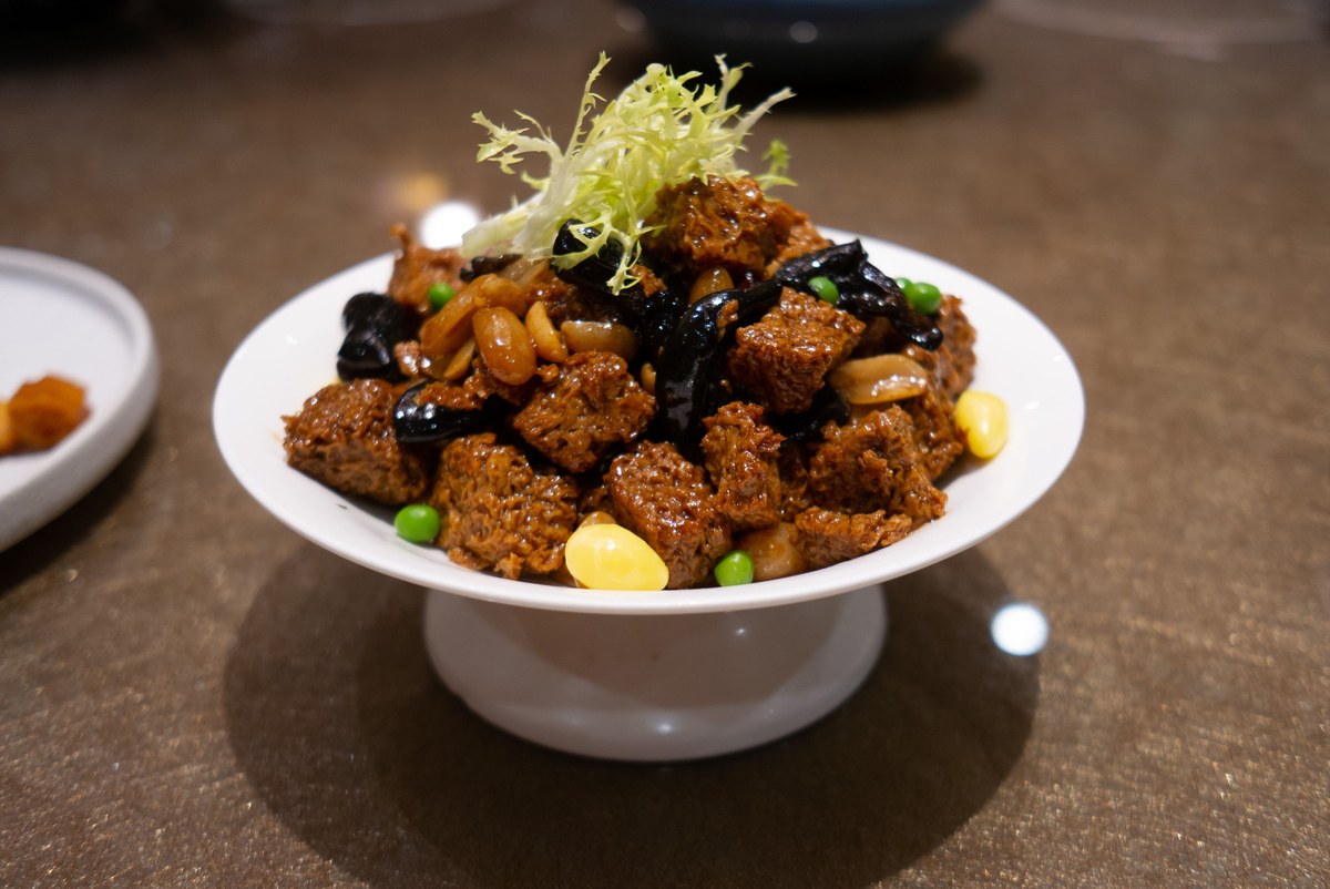 Shanghai braised wheat gluten kao fu with peanuts and mushrooms in soy sauce.