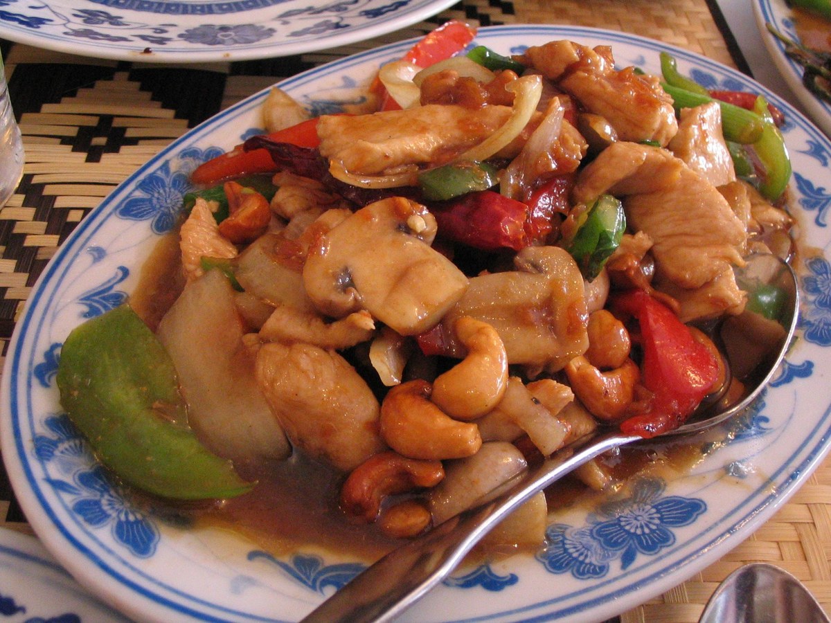 Cashew chicken stir-fry with chicken pieces, cashews, peppers, onion, and glossy sauce.