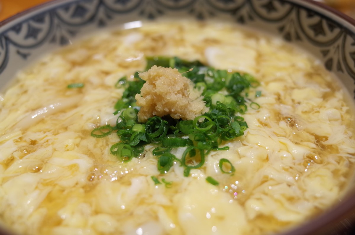 Chinese egg drop soup with soft egg ribbons in a clear broth.
