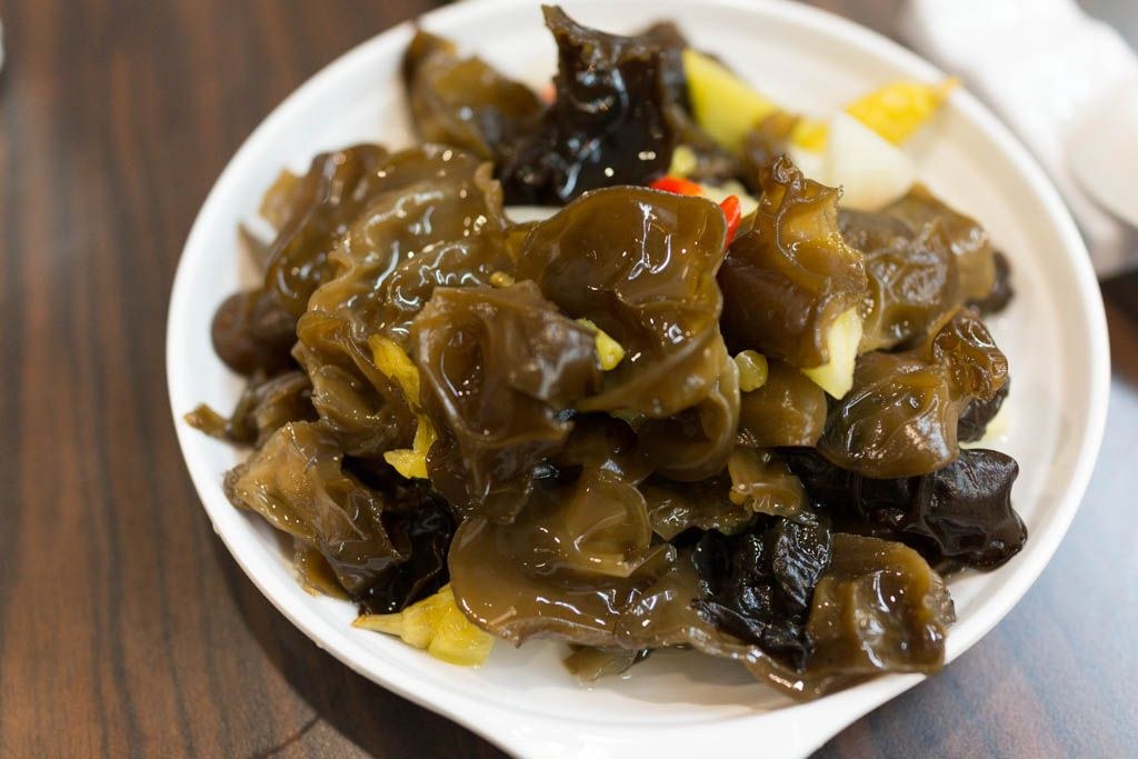 Cold wood ear mushroom salad with garlic and dressing in a bowl.