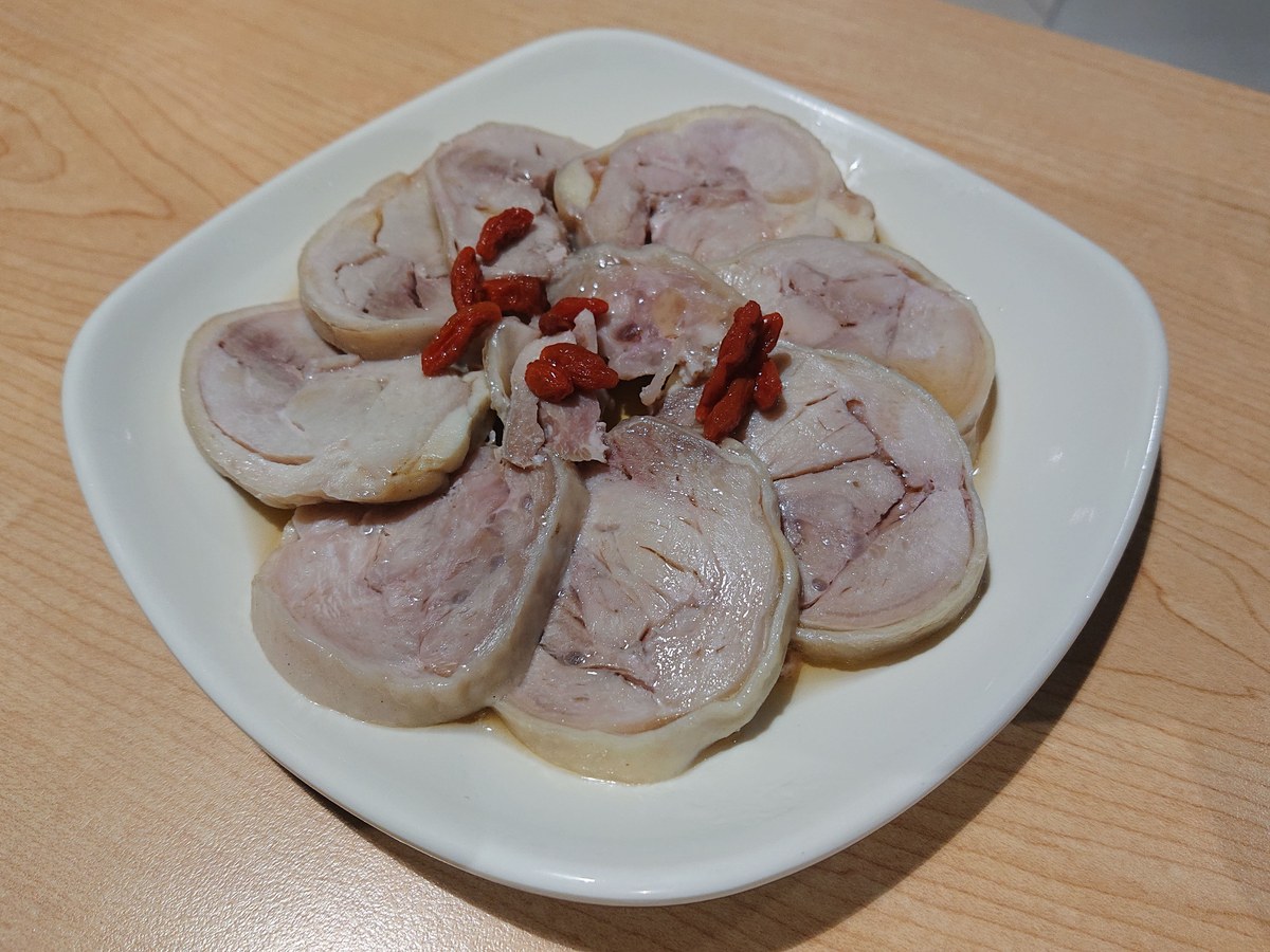 Drunken chicken sliced cold with Shaoxing wine marinade and goji garnish.