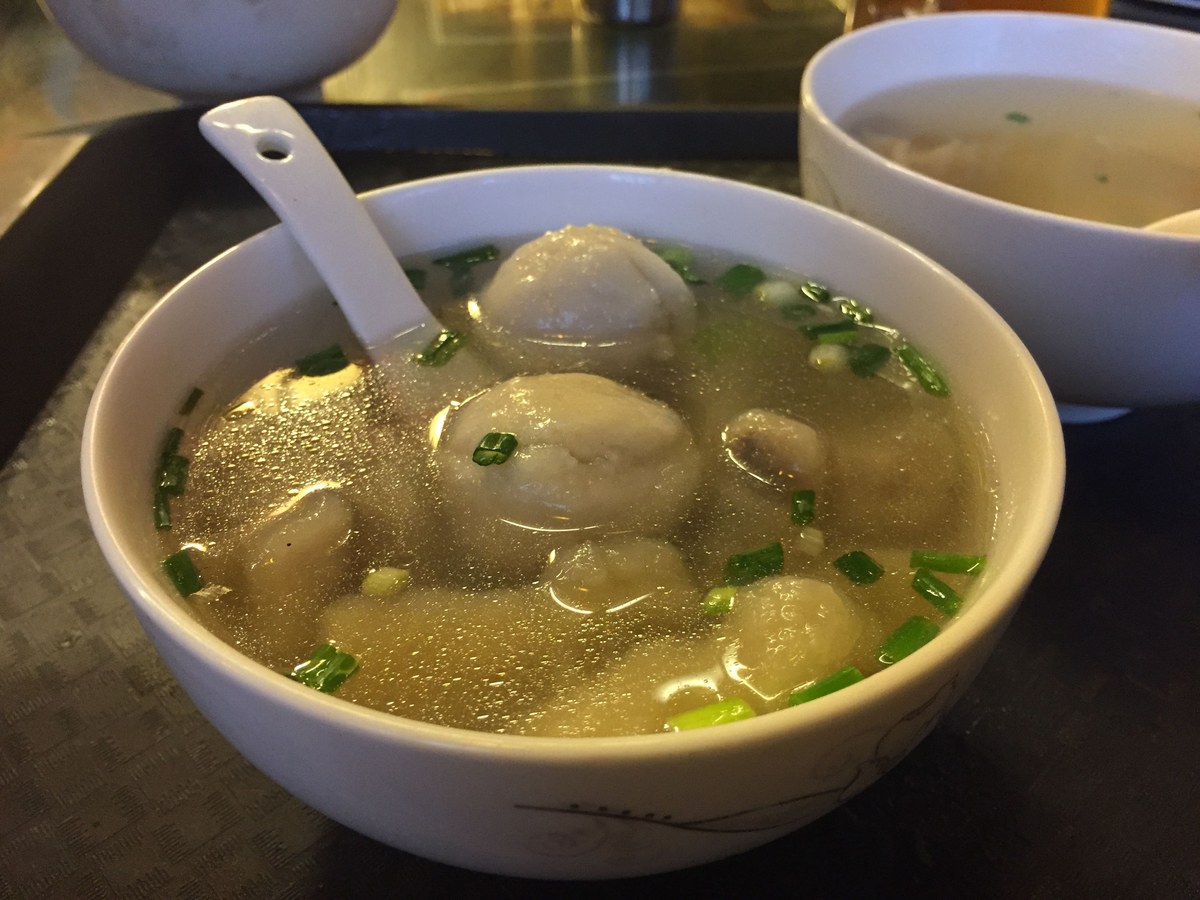 Fuzhou fish balls served in clear soup with broth and small garnishes