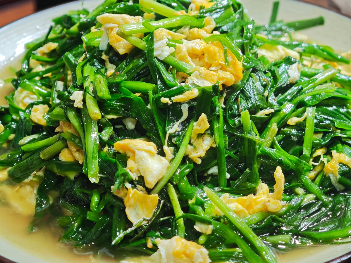 Chinese garlic chive eggs with soft yellow egg curds and green chive pieces.