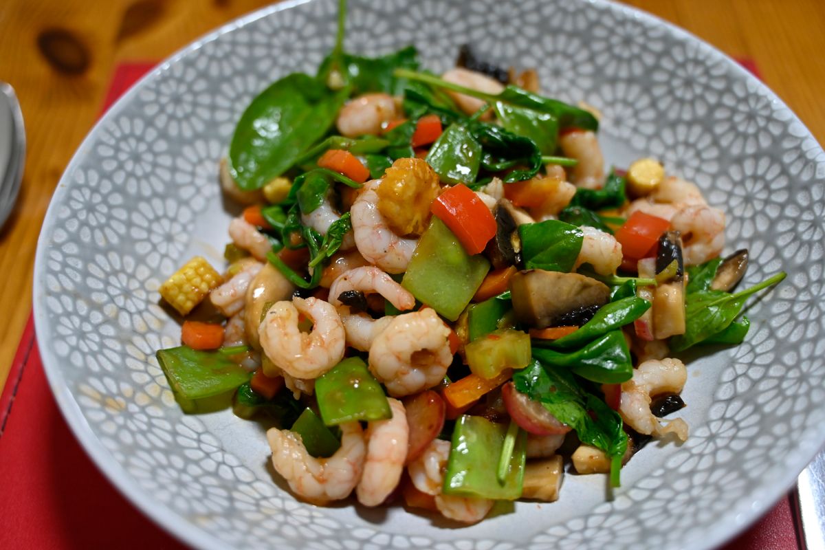 Chinese shrimp stir-fry with snow peas, greens, bell pepper, mushrooms, and light garlic sauce.