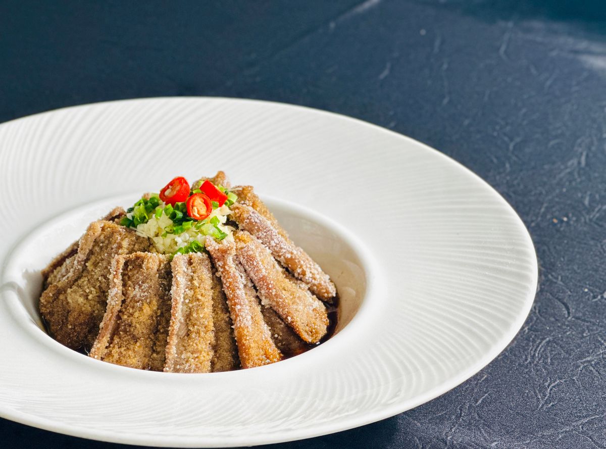Crispy Hunan eggplant strips with minced garlic, red chile, and scallions.