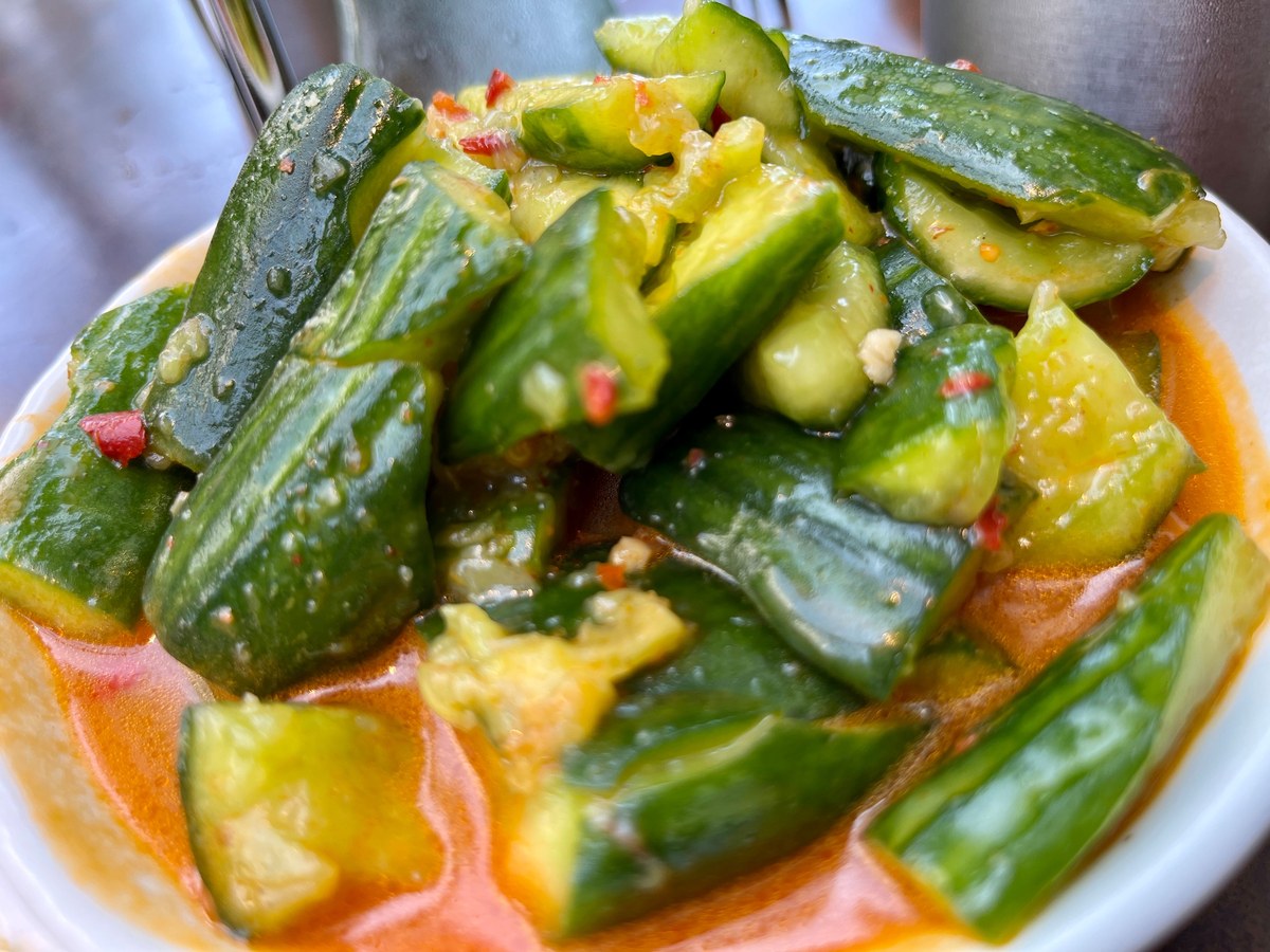 Chinese smashed cucumber salad with cracked cucumber pieces and chili garlic dressing.