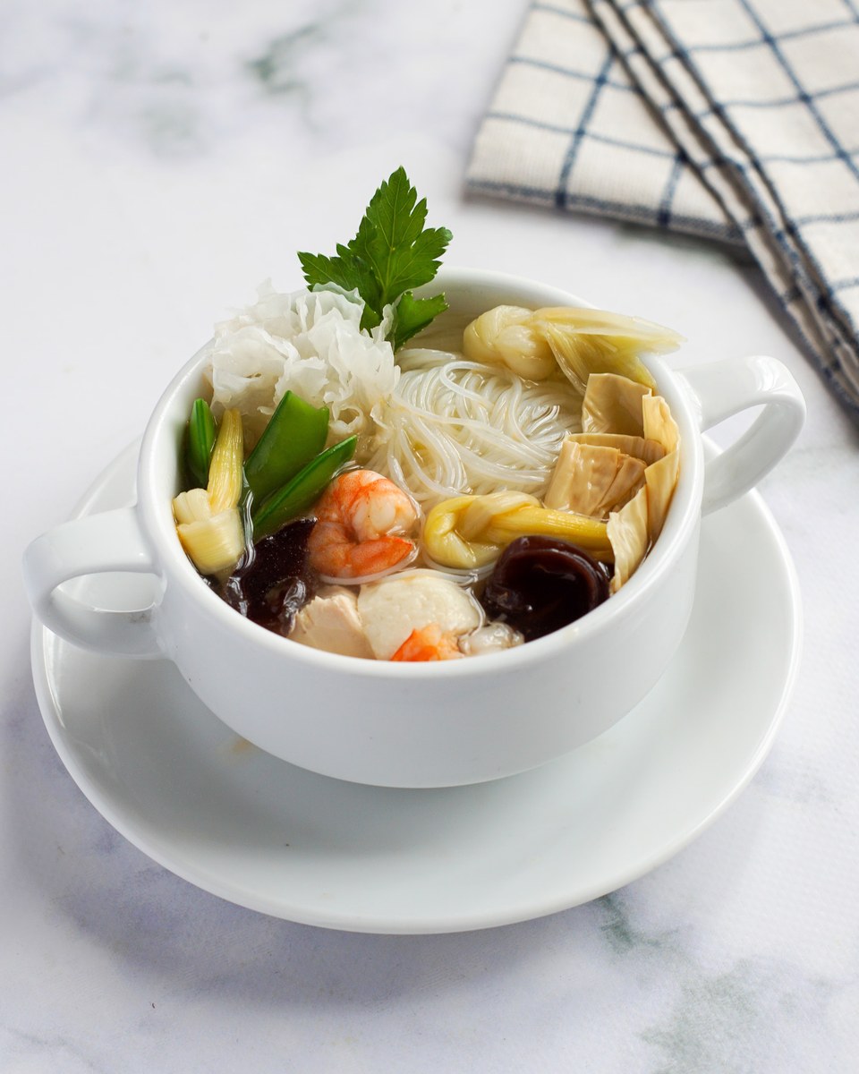 Jiaodong seafood noodle soup with shrimp, noodles, wood ear mushrooms, greens, and clear broth.