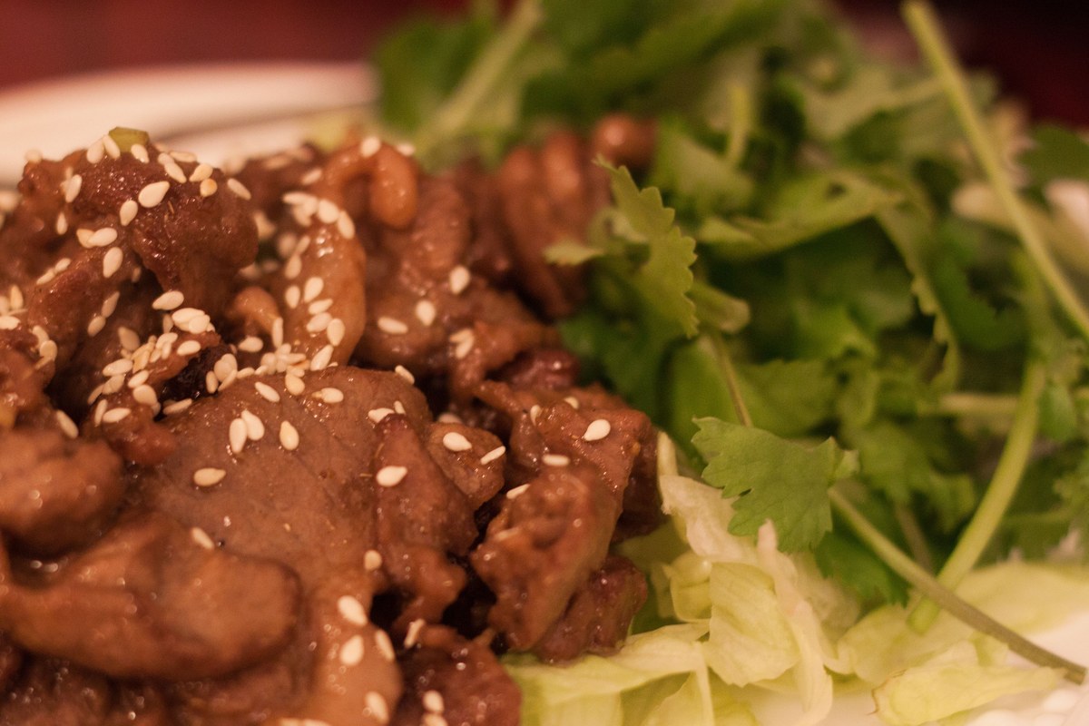 Xinjiang cumin lamb stir-fry with browned lamb pieces and toasted spices.
