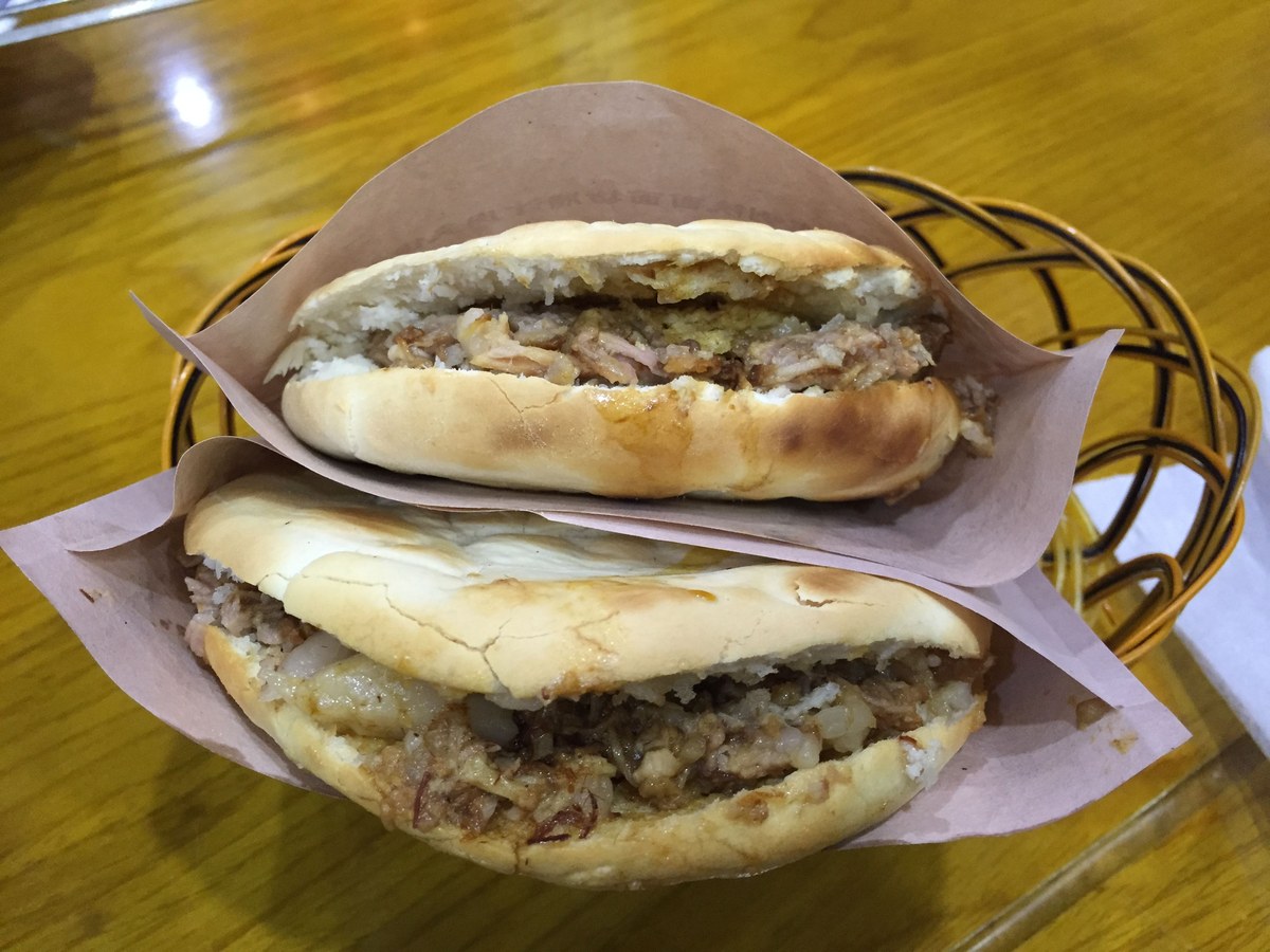 Rou jia mo flatbreads stuffed with chopped braised meat and served as Shaanxi street food.