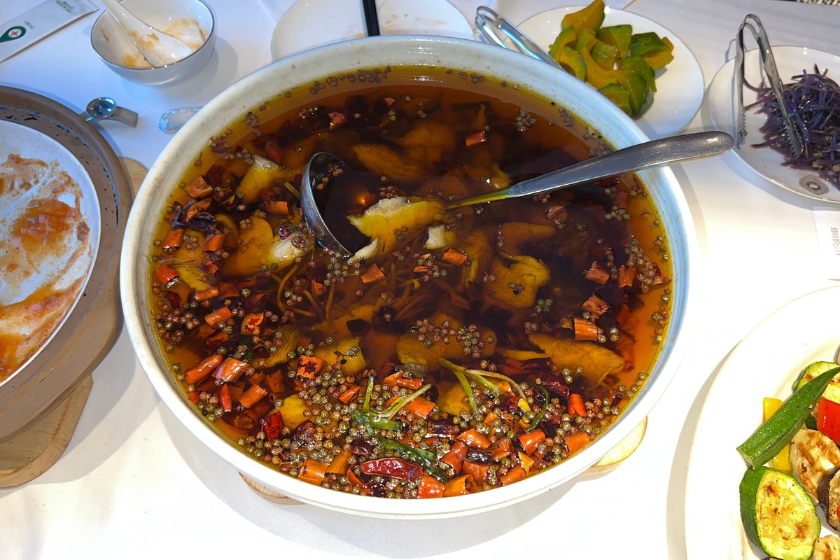 Sichuan boiled fish with red chili oil, fish fillets, and Sichuan pepper topping.