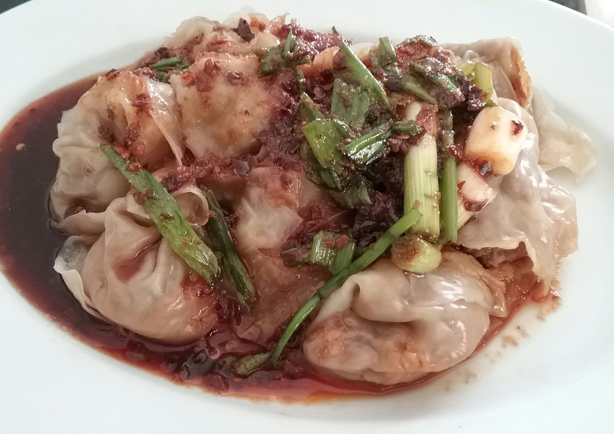 Sichuan red oil wontons coated in glossy chili oil sauce.