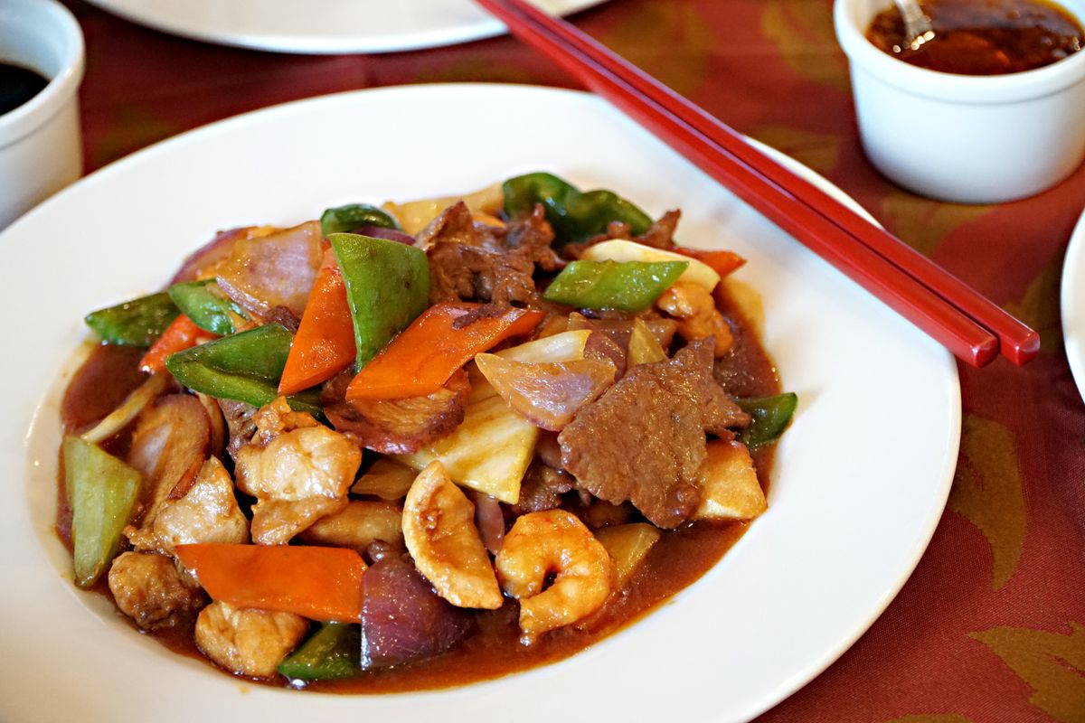 Chinese Triple Delight stir-fry with shrimp, beef, chicken, snow peas, carrot, onion, and brown sauce.