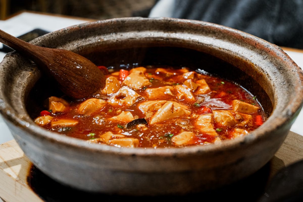 Spicy braised tofu simmering in a glossy red sauce.
