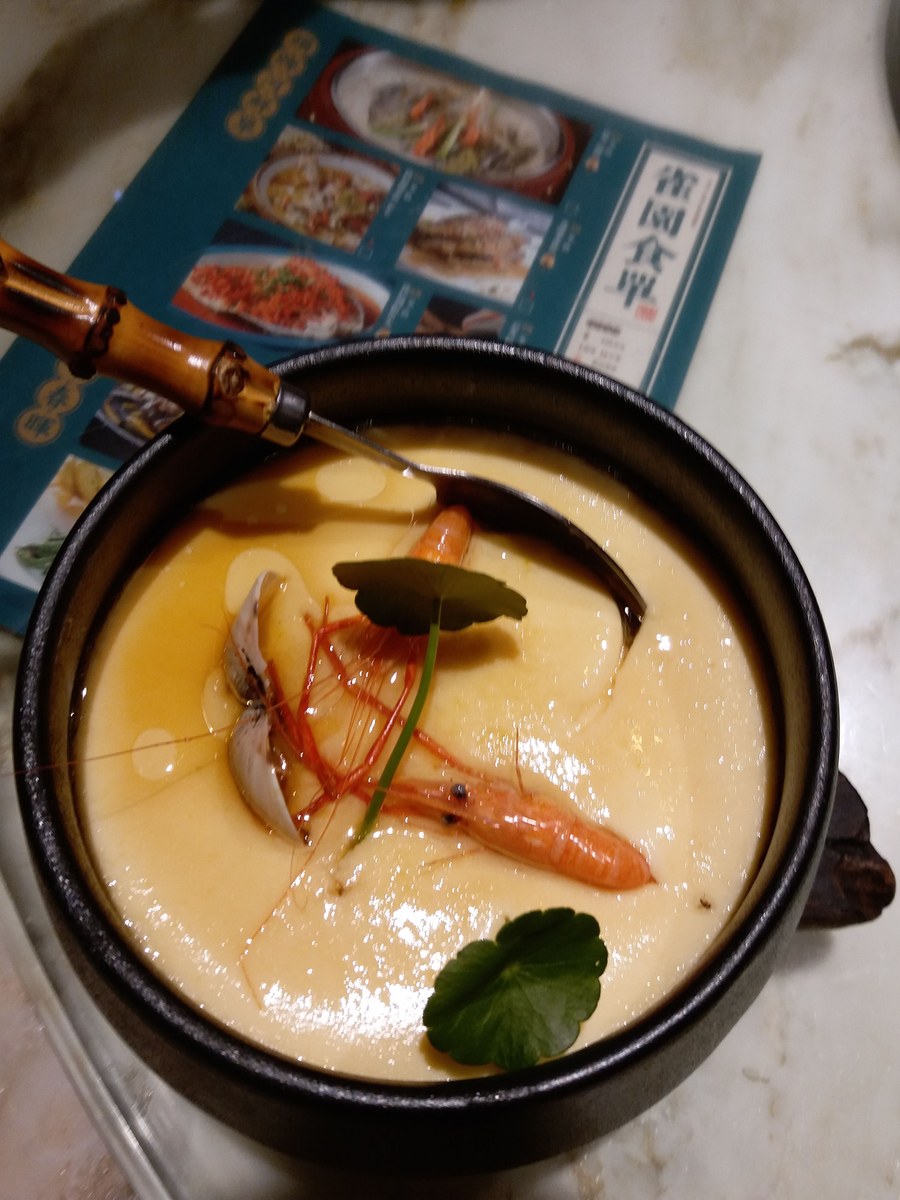 Chinese steamed egg custard with smooth surface, shrimp, clam, and scallion garnish.