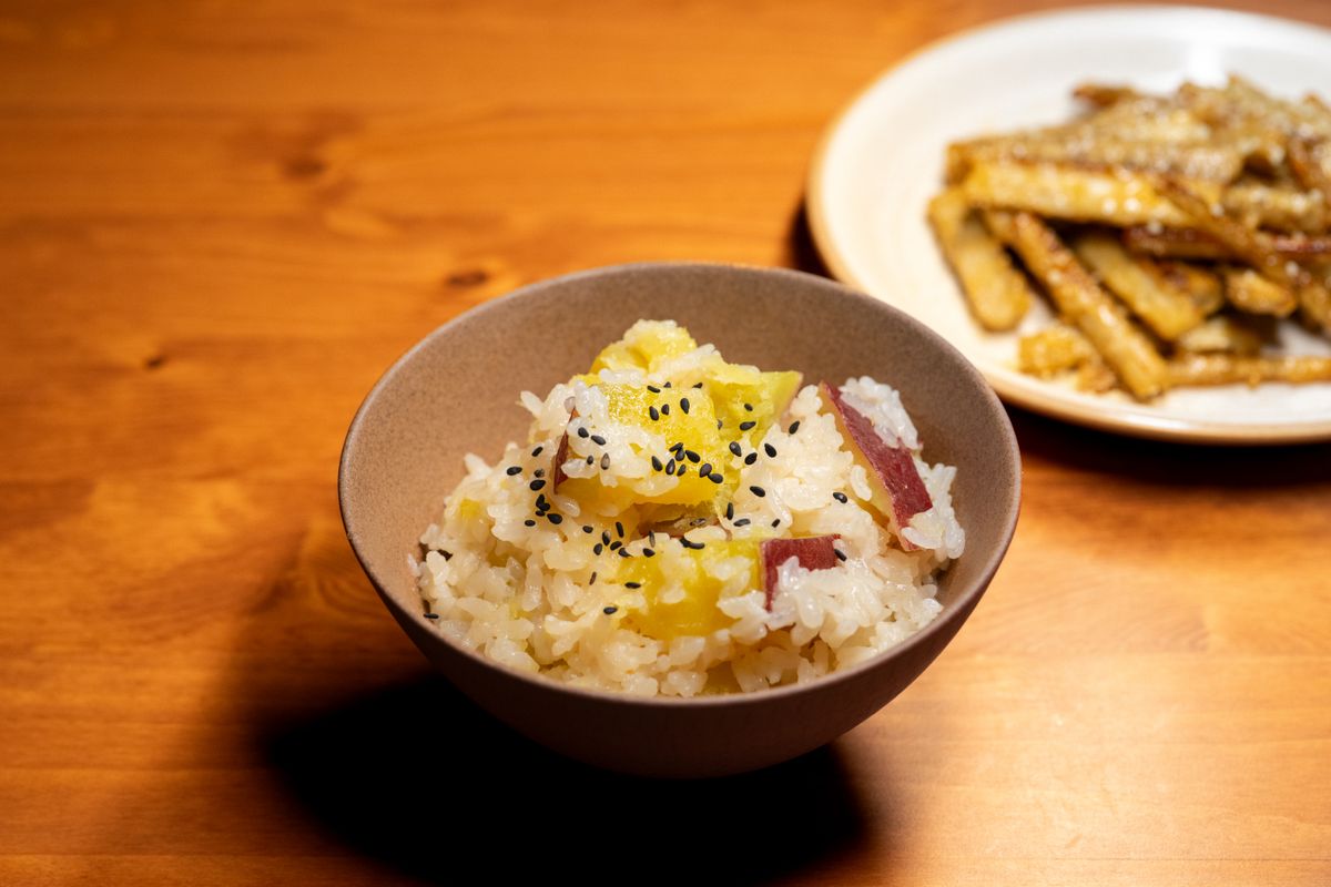 Sweet potato rice with golden sweet potato cubes and black sesame seeds.