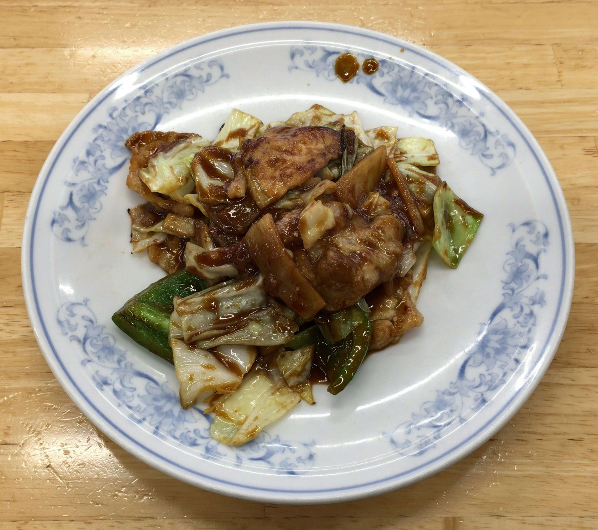 Twice-cooked pork with browned pork slices, cabbage, and glossy sauce.