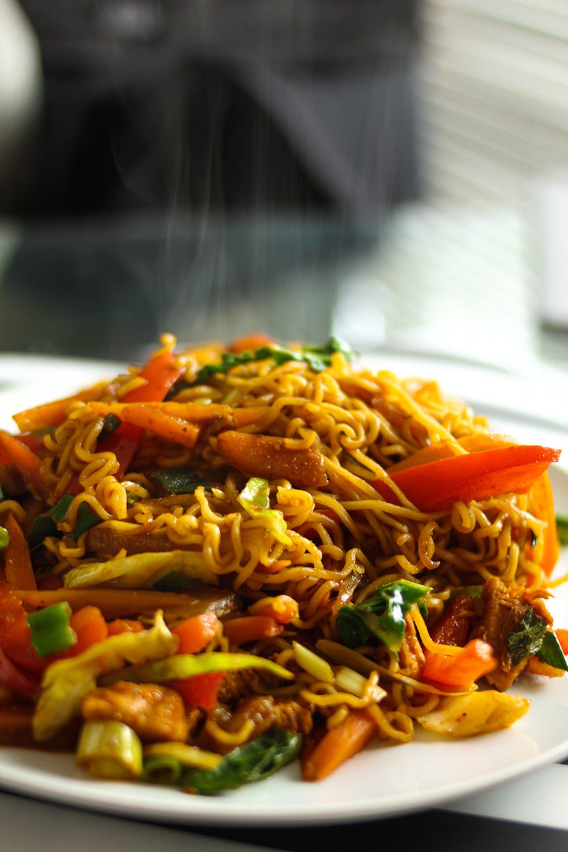 Vegetable chow mein noodles with cabbage, carrots, and glossy stir-fry sauce.