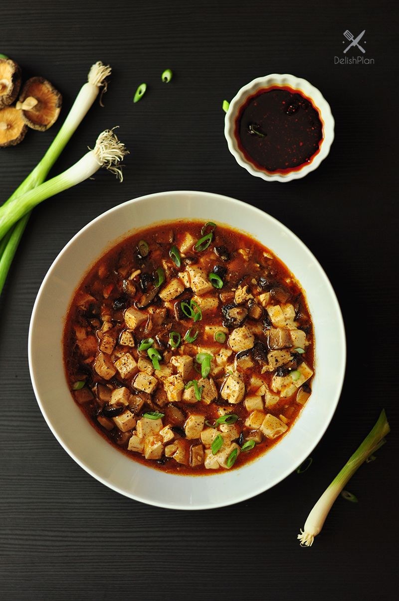 Vegan mapo tofu with soft tofu cubes in a red Sichuan sauce.