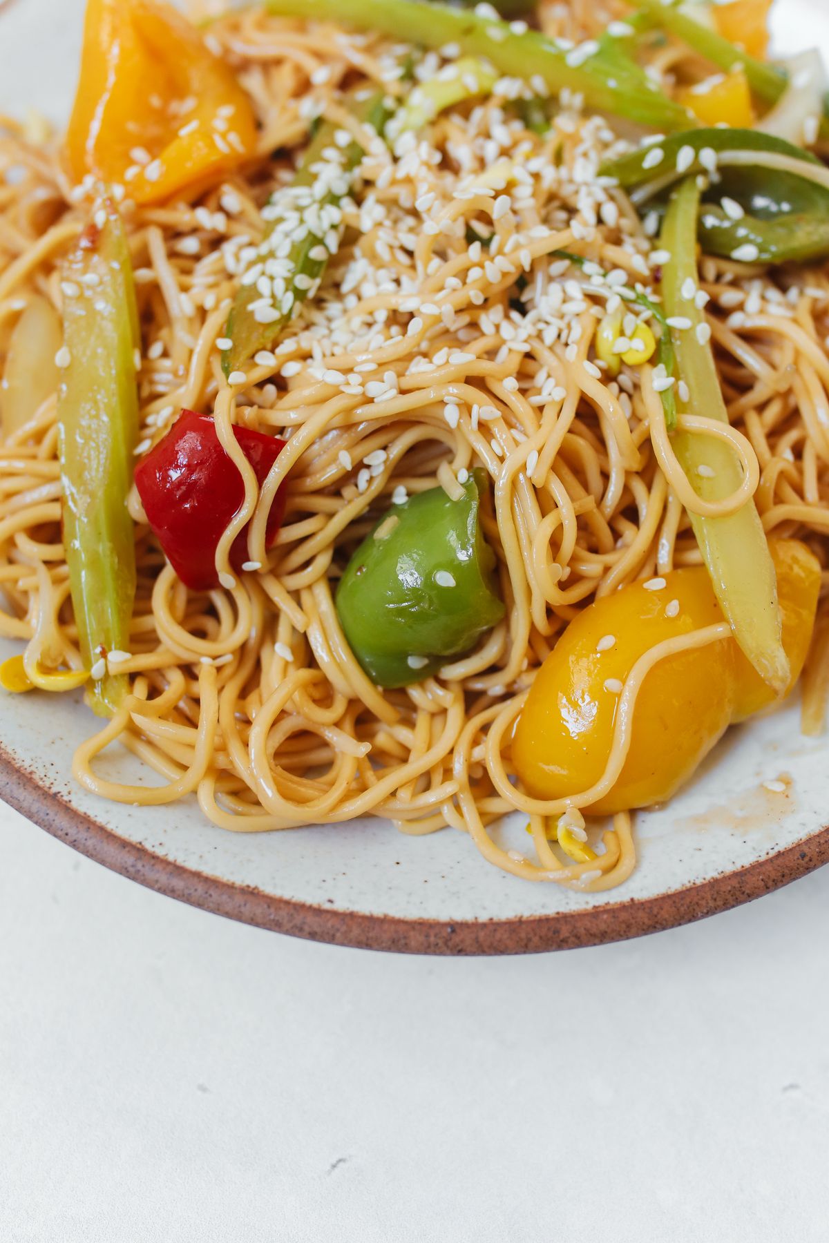 Sesame bell pepper noodles with scallions, green beans, sweet peppers, and toasted sesame seeds.