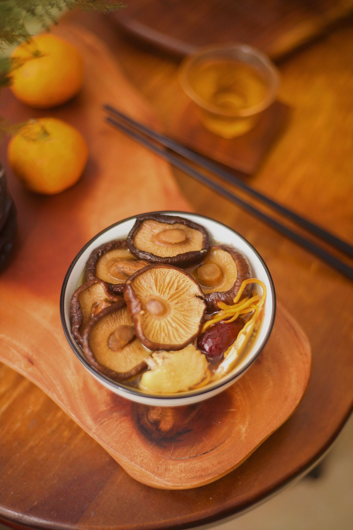 Shiitake red date chicken soup with whole mushrooms, ginger, goji berries, and clear broth.
