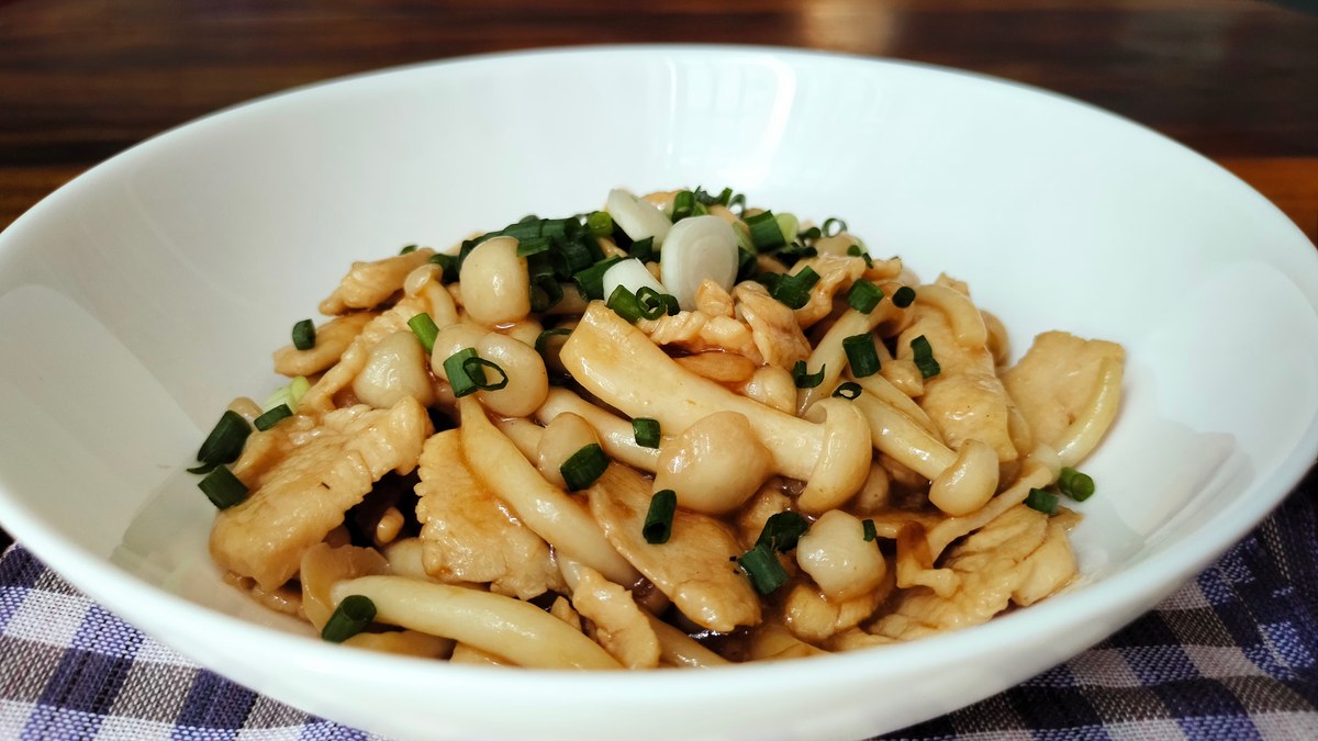 Yunnan mushroom stir-fry with white shimeji mushrooms, chives, garlic, and light soy gloss.