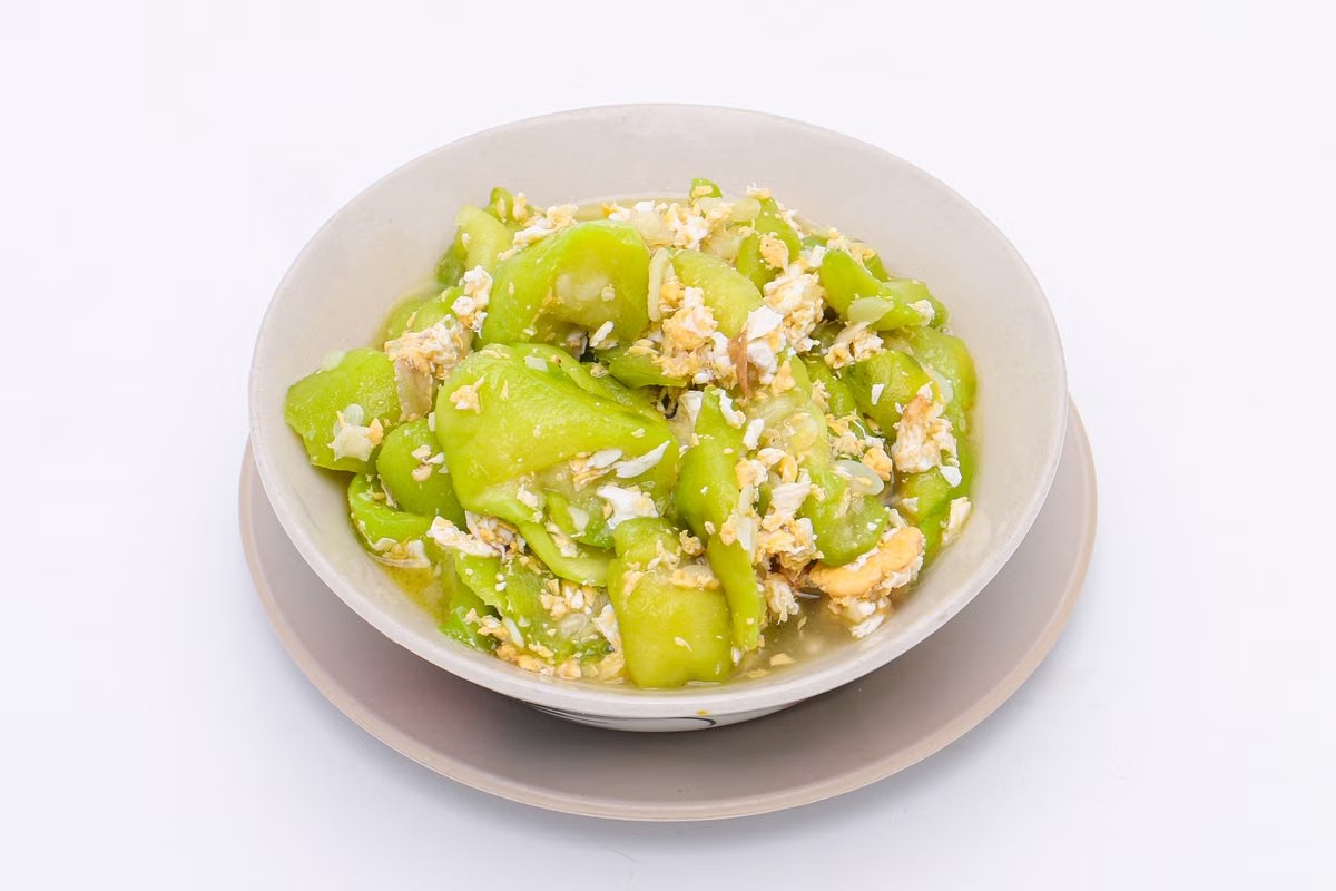 Zucchini and egg stir-fry with soft green squash and scrambled egg.